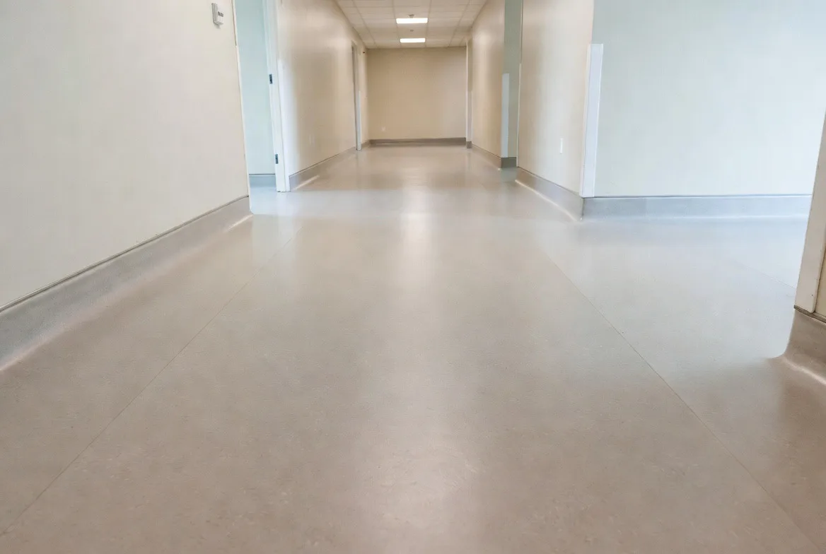 Vinyl sheet flooring with heat-welded seams