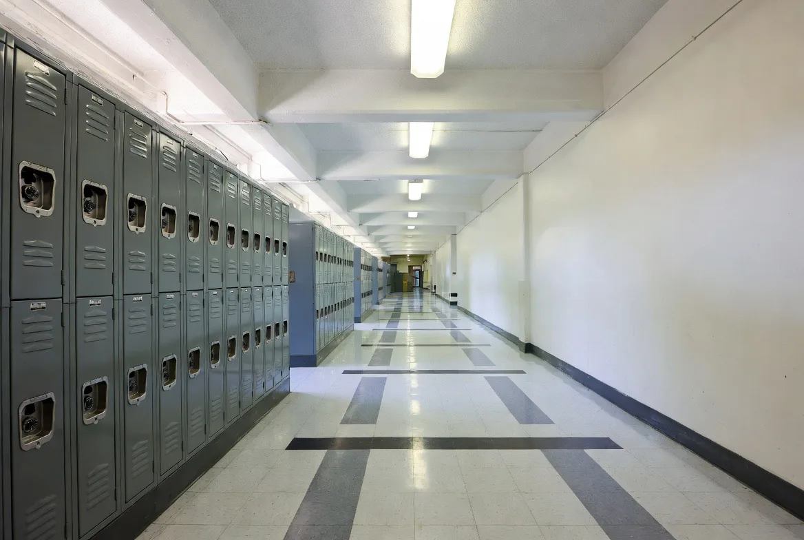 Tile flooring in a school hallway lined with lockers