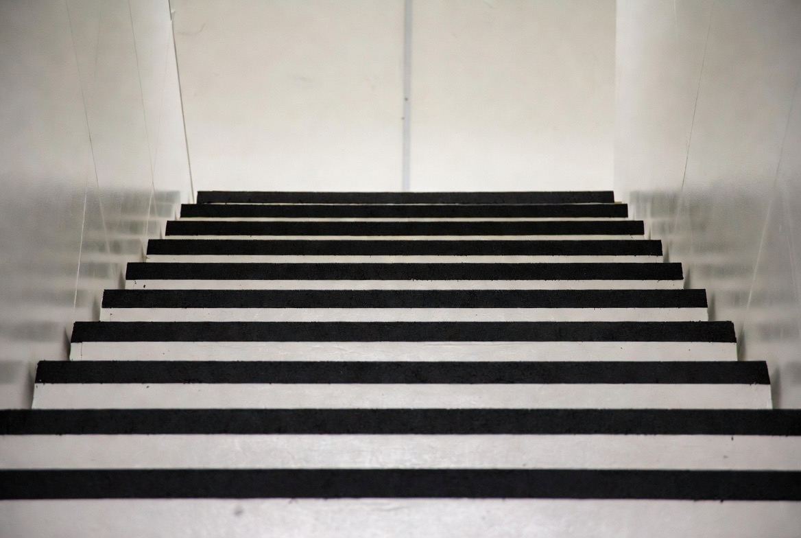 Black rubber stair treads in a commercial stairwell